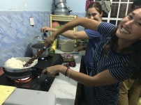 Ariel cooking Ugali, as Sierra cooks some veggies